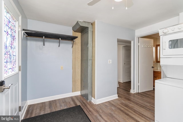 3135 Sollers Point Rd, Baltimore, MD 21222 - laundry room featuring stacked washer and clothes dryer, wood finished floors, a ceiling fan, and baseboards