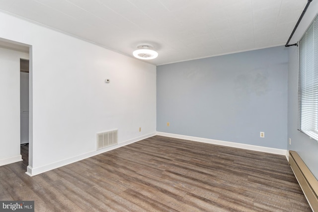 3135 Sollers Point Rd, Baltimore, MD 21222 - empty room with baseboard heating, wood finished floors, baseboards, and ornamental molding