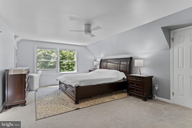 carpeted bedroom featuring vaulted ceiling, a ceiling fan, and baseboards