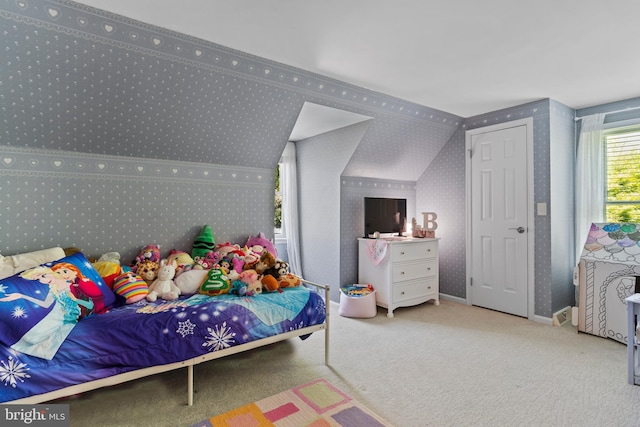 carpeted bedroom featuring wallpapered walls and baseboards