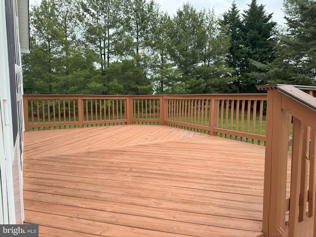 wooden deck with view of scattered trees