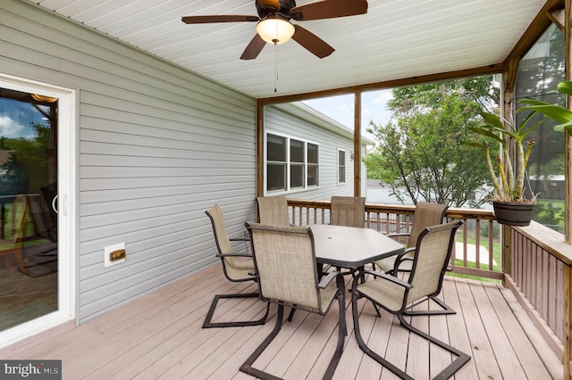 wooden deck featuring outdoor dining space and ceiling fan