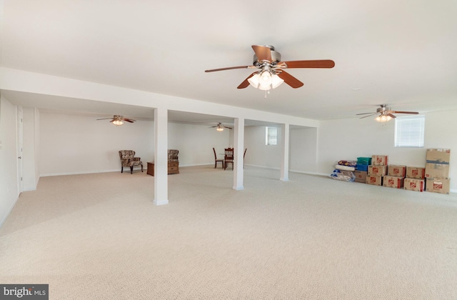 basement featuring carpet and ceiling fan