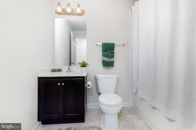 bathroom featuring toilet, vanity, baseboards, tile patterned flooring, and shower / bath combo with shower curtain