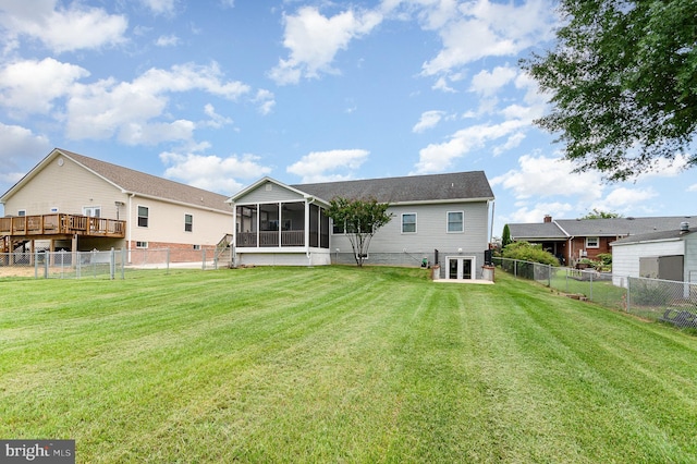 rear view of house featuring a sunroom and french doors