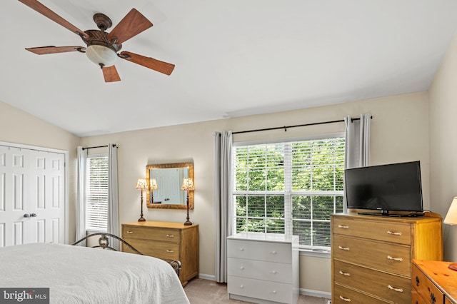 bedroom featuring multiple windows, baseboards, vaulted ceiling, light colored carpet, and ceiling fan