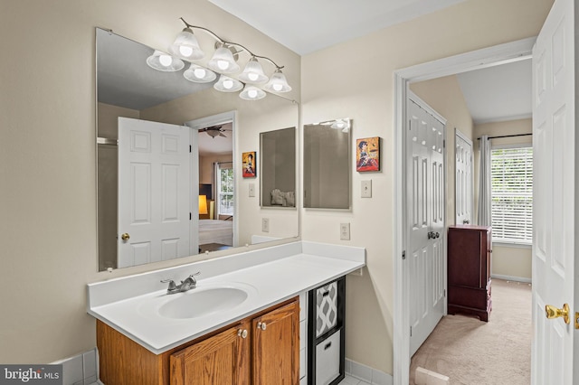 ensuite bathroom with vanity and baseboards