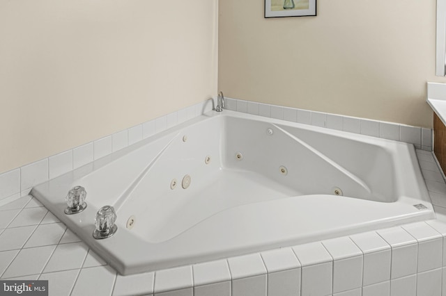 full bathroom featuring vanity and a tub with jets