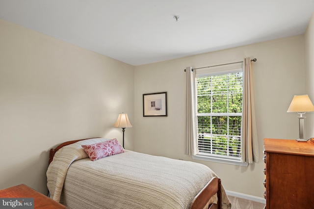 carpeted bedroom with baseboards