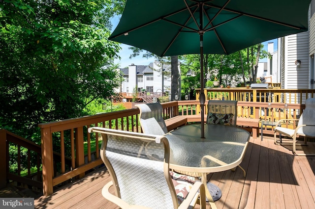 deck with outdoor dining space and a residential view