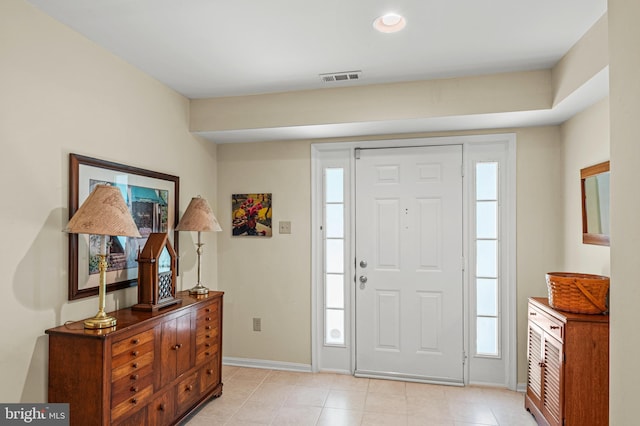 entrance foyer featuring baseboards and light tile patterned flooring
