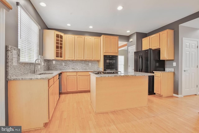 43413 Countrywalk Ct, Ashburn, VA 20147 - kitchen featuring light brown cabinets, a sink, light wood-style floors, glass insert cabinets, and recessed lighting