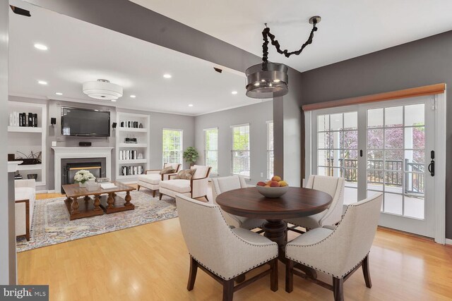 43413 Countrywalk Ct, Ashburn, VA 20147 - dining space with light wood-style flooring, recessed lighting, a glass covered fireplace, and built in features