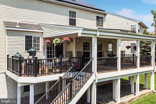 43413 Countrywalk Ct, Ashburn, VA 20147 - back of property with stairway, roof mounted solar panels, and a wooden deck
