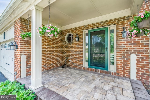 43413 Countrywalk Ct, Ashburn, VA 20147 - property entrance featuring brick siding, an attached garage, and a porch