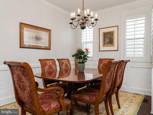 816 Bay Ridge Ave, Annapolis, MD 21403 - dining room featuring a chandelier, ornamental molding, light wood-type flooring, and a decorative wall