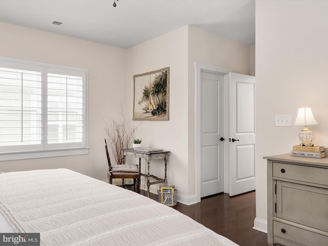 816 Bay Ridge Ave, Annapolis, MD 21403 - bedroom featuring dark wood-style floors, multiple windows, and baseboards