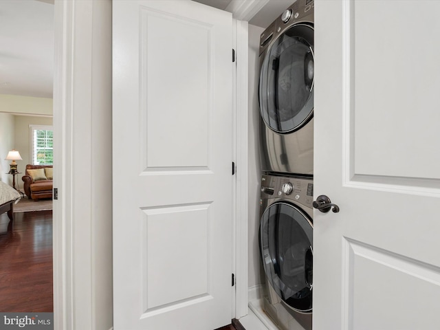 816 Bay Ridge Ave, Annapolis, MD 21403 - clothes washing area featuring stacked washing machine and dryer and dark wood-type flooring