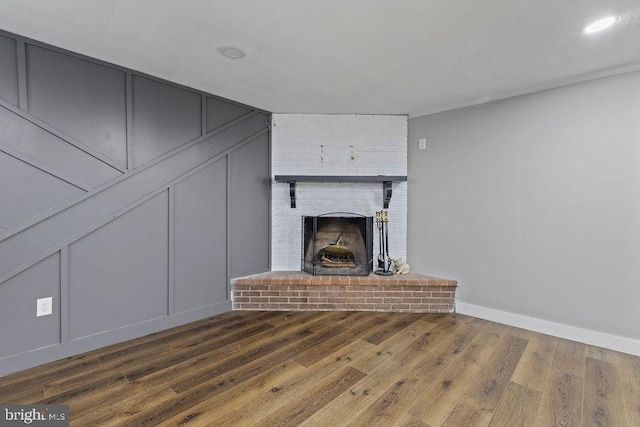 1604 Old New Windsor Rd, New Windsor, MD 21776 - unfurnished living room featuring a fireplace, wood finished floors, a decorative wall, baseboards, and recessed lighting