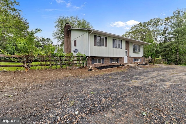 1604 Old New Windsor Rd, New Windsor, MD 21776 - bi-level home featuring a chimney, fence, and brick siding