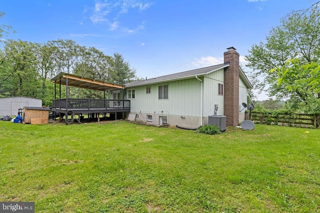 1604 Old New Windsor Rd, New Windsor, MD 21776 - back of house with a wooden deck, a chimney, central air condition unit, a shed, and an outbuilding