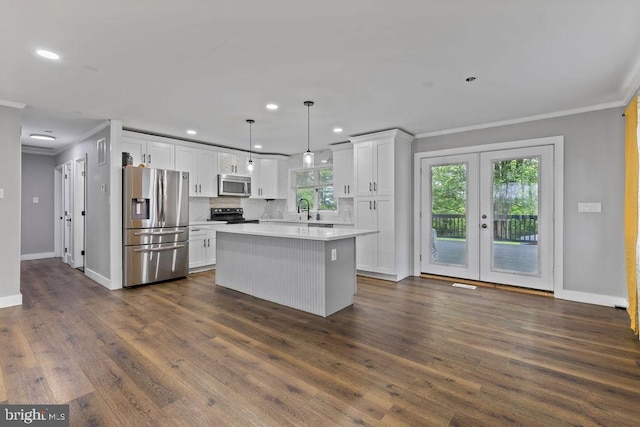 1604 Old New Windsor Rd, New Windsor, MD 21776 - kitchen featuring stainless steel appliances, ornamental molding, white cabinets, a kitchen island, and baseboards