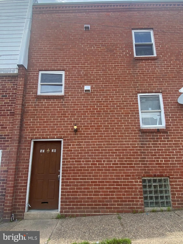 view of exterior entry with brick siding