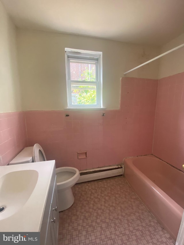 full bathroom featuring a baseboard radiator, tile walls, toilet, tile patterned floors, and a wainscoted wall
