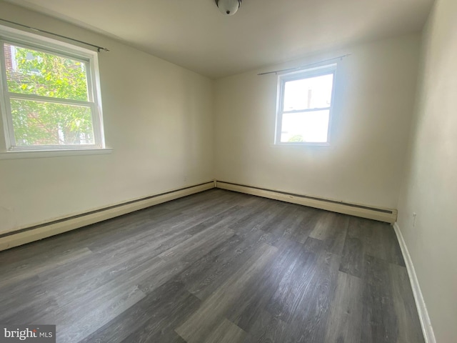 spare room featuring wood finished floors and baseboards