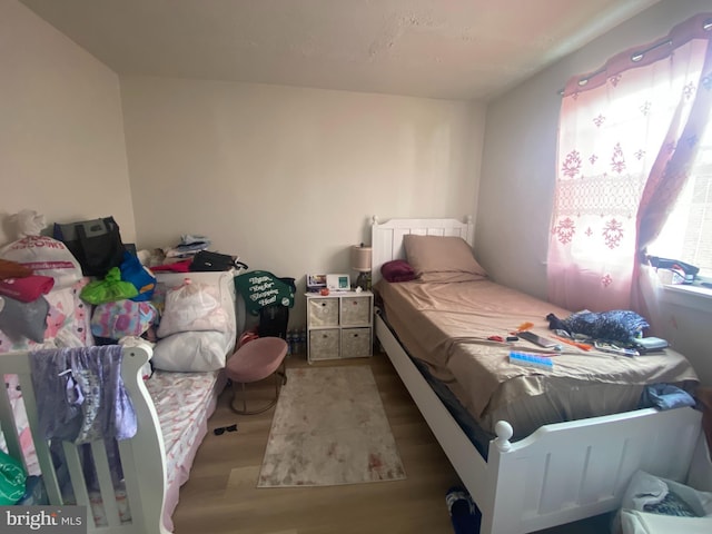 bedroom featuring wood finished floors