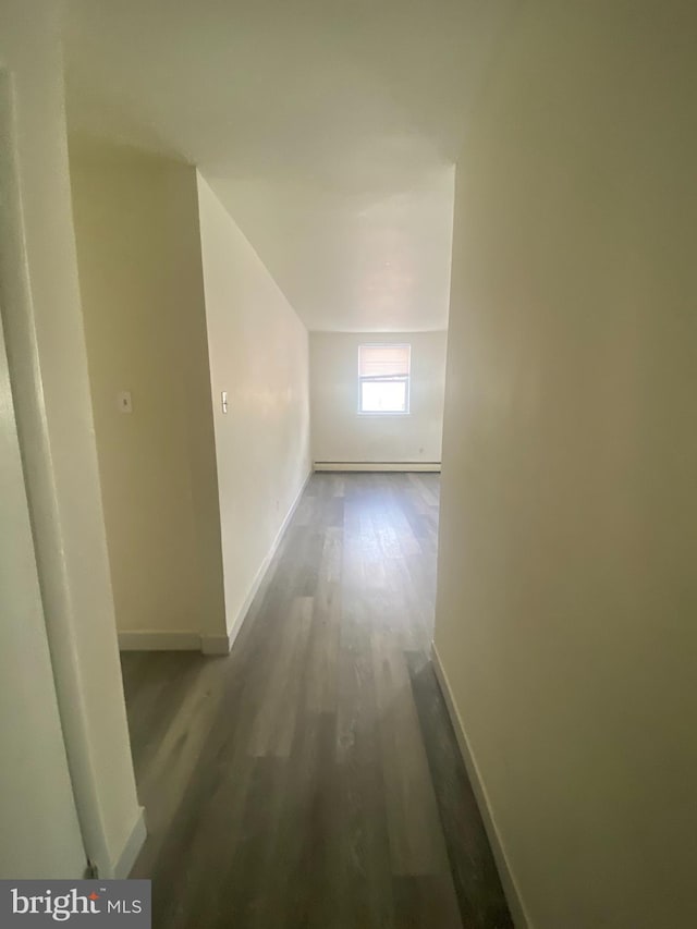 hall featuring baseboards and wood finished floors