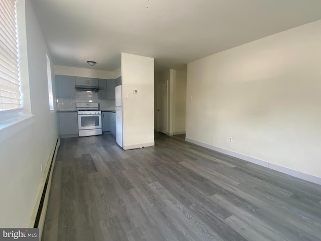 unfurnished living room featuring baseboards, dark wood-style flooring, and baseboard heating