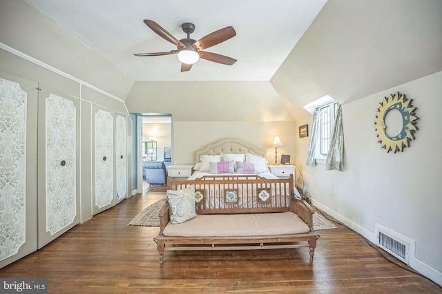 bedroom featuring multiple windows, wood finished floors, vaulted ceiling, and a ceiling fan