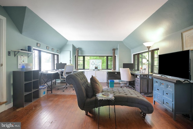 living area featuring lofted ceiling, an office area, and wood-type flooring