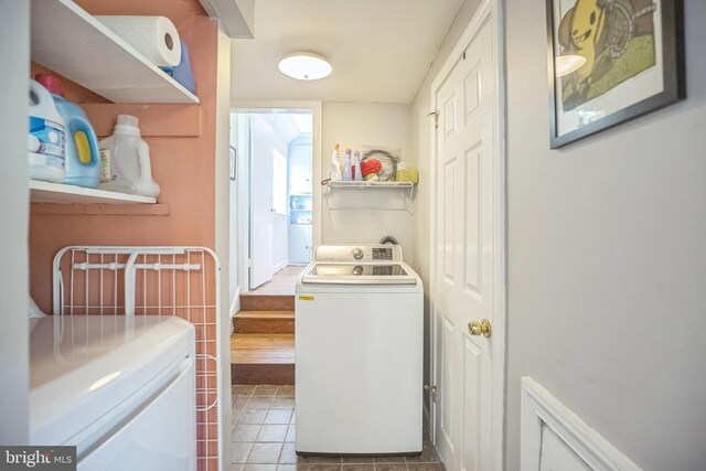 laundry area featuring washing machine and dryer and tile patterned floors