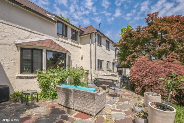 view of patio with cooling unit and an outdoor living space