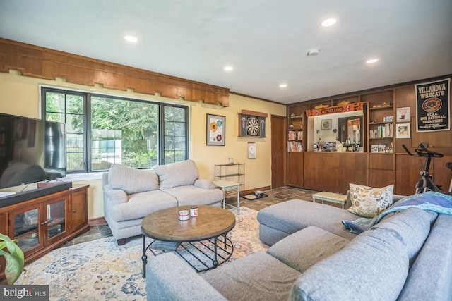 living area with baseboards, recessed lighting, and stone finish floors