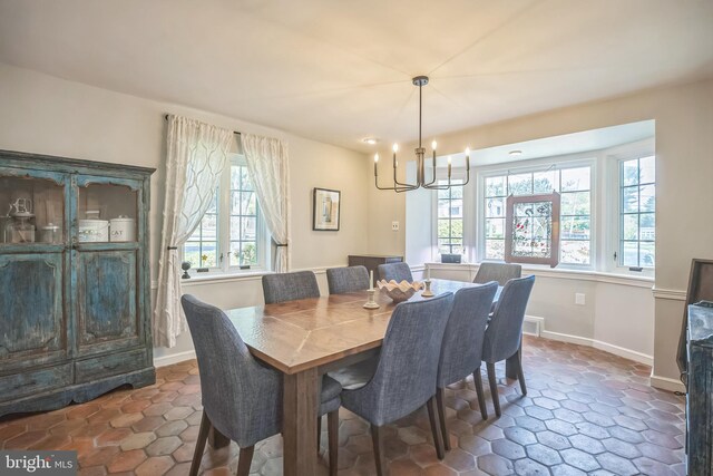 dining space with a chandelier and baseboards