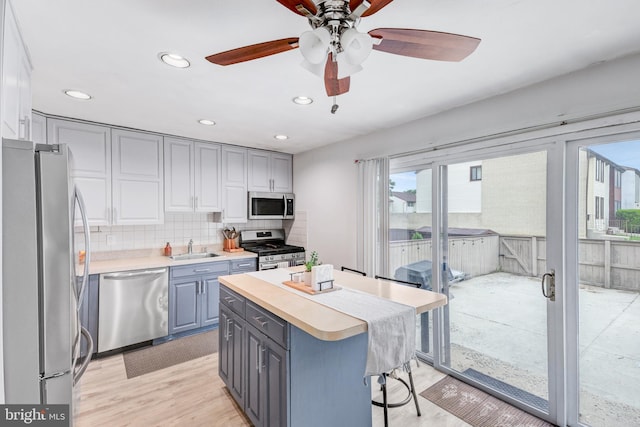 384 Bolton Rd, East Windsor, NJ 08520 - kitchen with appliances with stainless steel finishes, gray cabinetry, a sink, light countertops, and recessed lighting