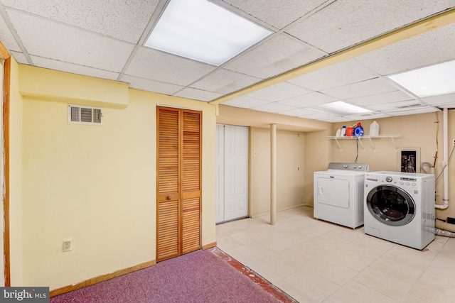 384 Bolton Rd, East Windsor, NJ 08520 - laundry area featuring washer and clothes dryer, tile patterned floors, and baseboards