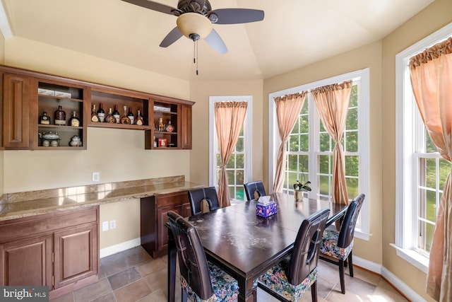 dining space with baseboards and ceiling fan