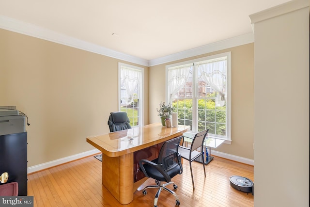 office space with crown molding, baseboards, and light wood-style flooring