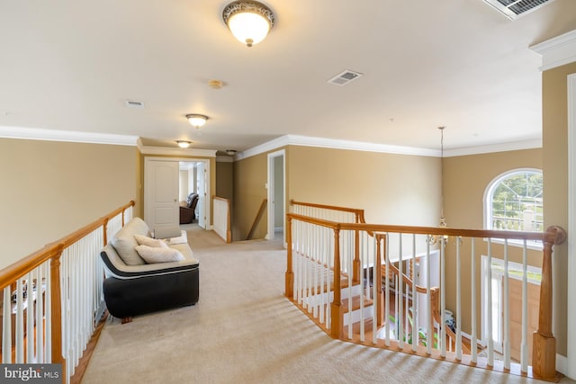 hall featuring an upstairs landing, crown molding, and carpet floors
