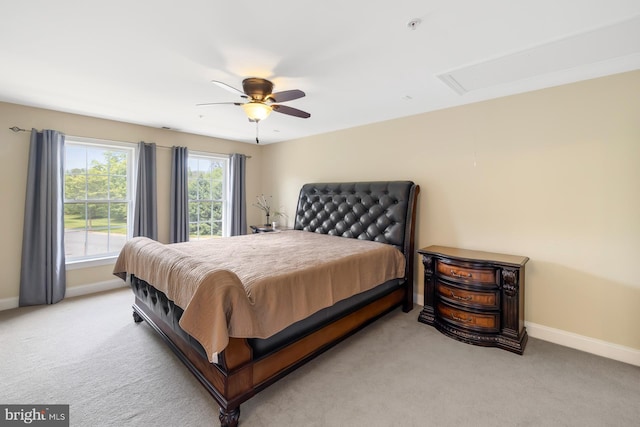bedroom featuring light carpet, baseboards, and a ceiling fan