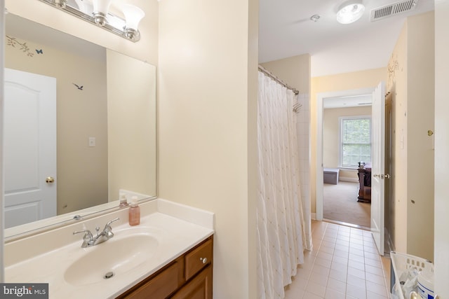 bathroom with tile patterned flooring, vanity, and baseboards