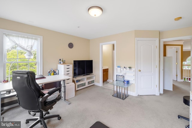 carpeted home office featuring baseboards
