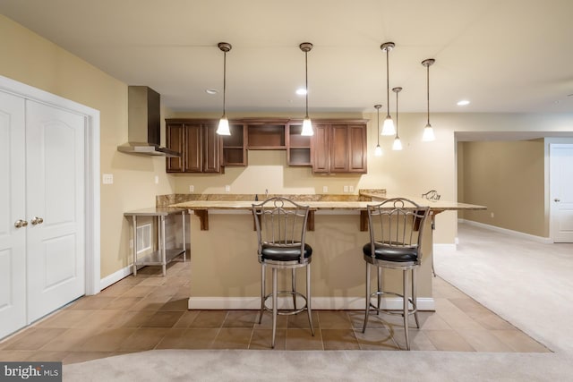 kitchen featuring wall chimney range hood, a breakfast bar area, recessed lighting, baseboards, and open shelves