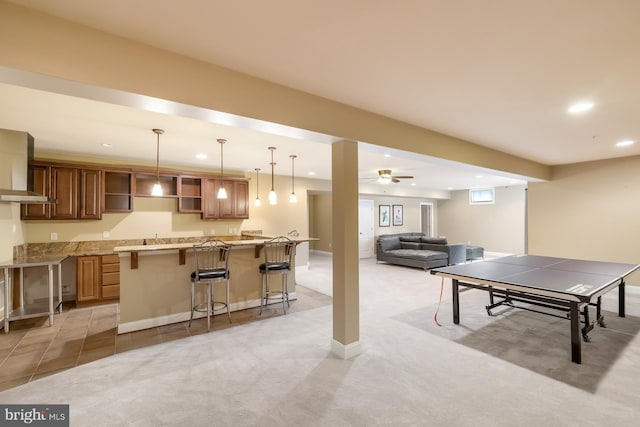 rec room with recessed lighting, light carpet, bar with sink, and a ceiling fan