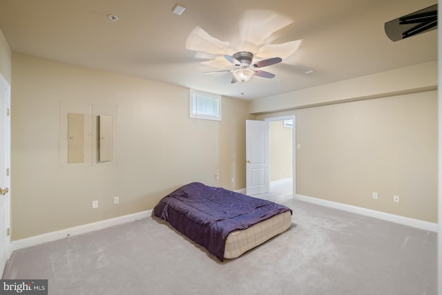 carpeted bedroom featuring baseboards and a ceiling fan