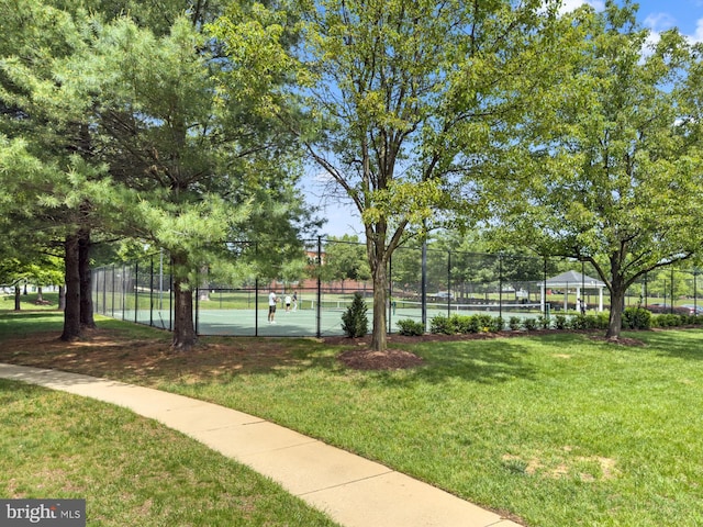 view of property's community with a tennis court